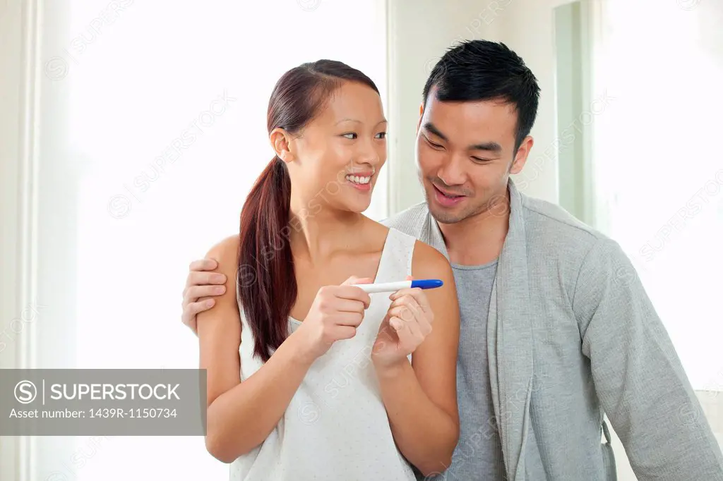 Couple taking pregnancy test in bathroom