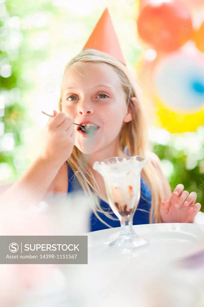 Girl having ice cream sundae at party