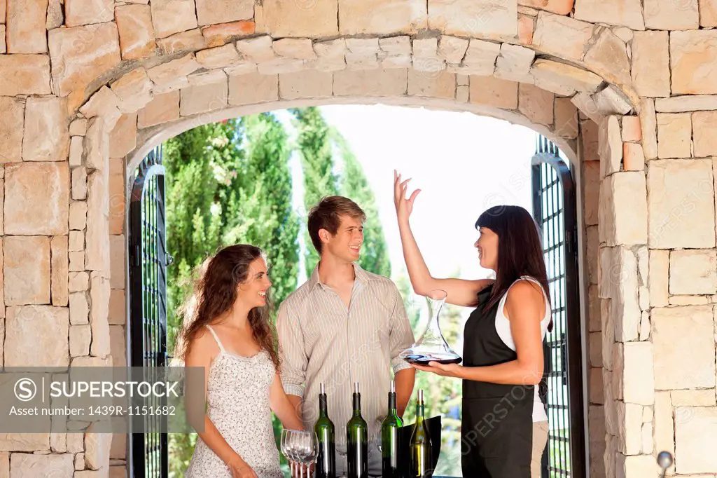 Couple tasting wine in doorway