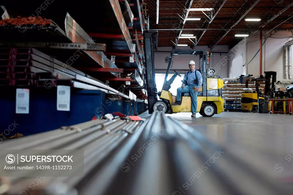 Worker standing in metal plant