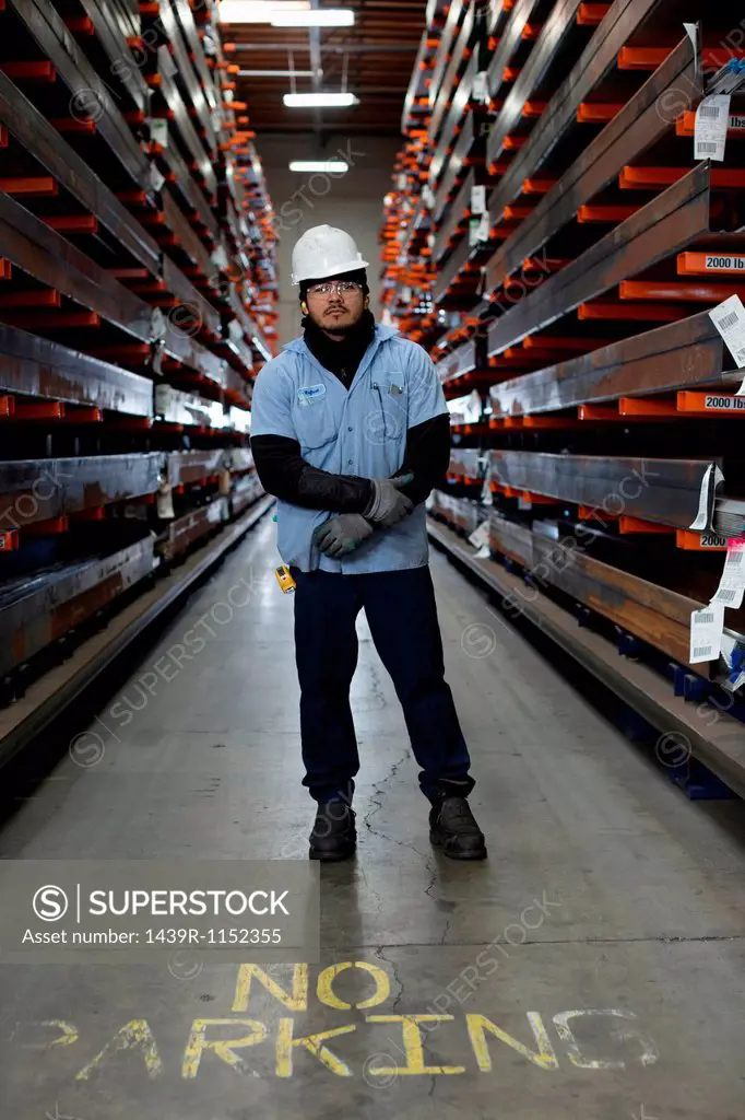 Worker standing in metal plant