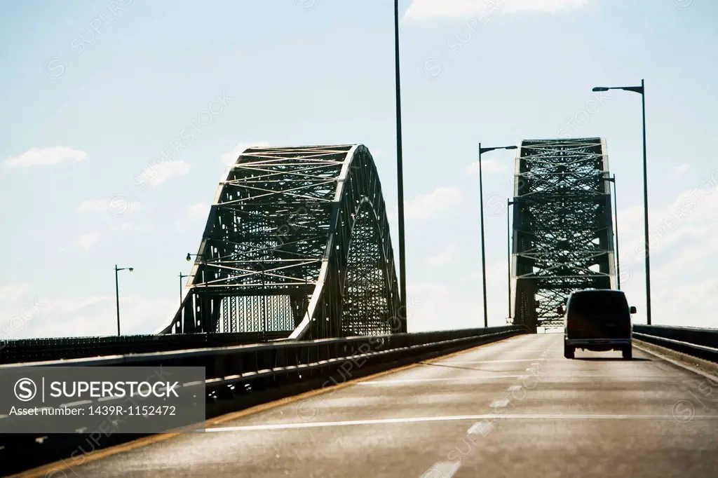 Van driving on bridge