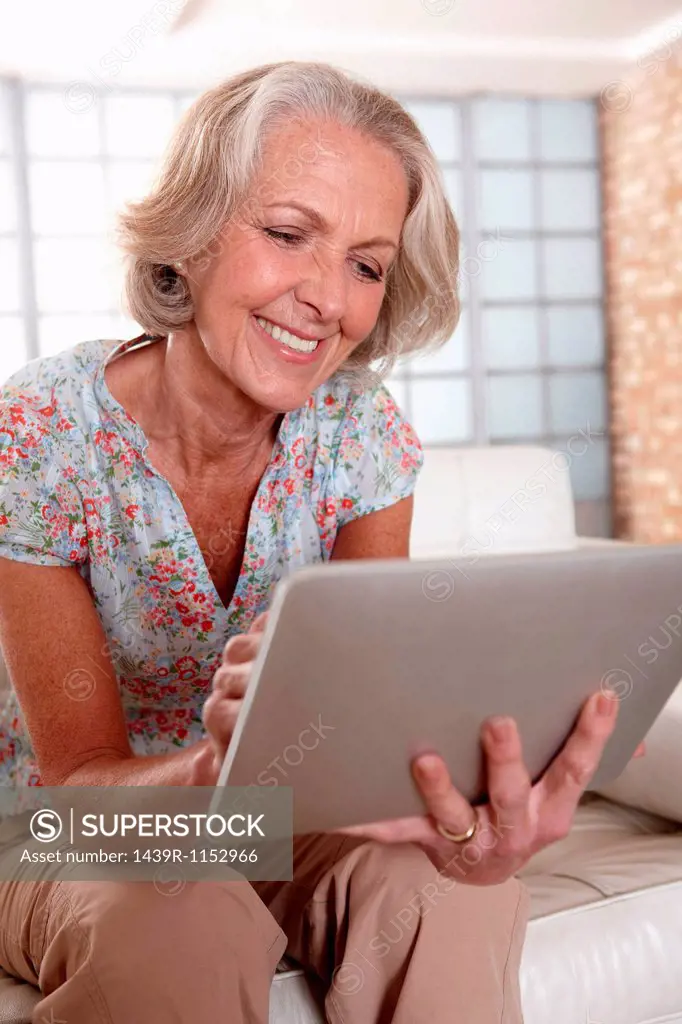 Older woman using tablet computer