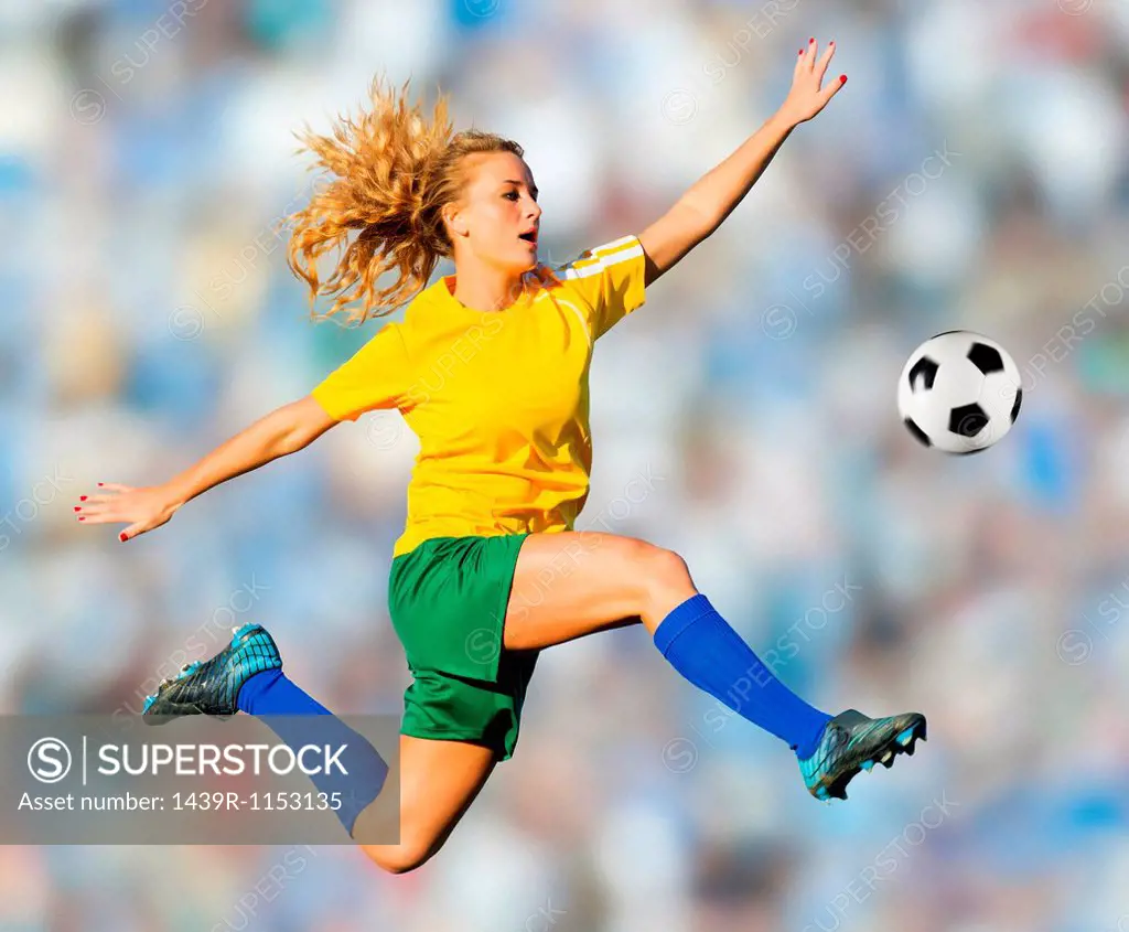 Soccer player kicking in mid-air