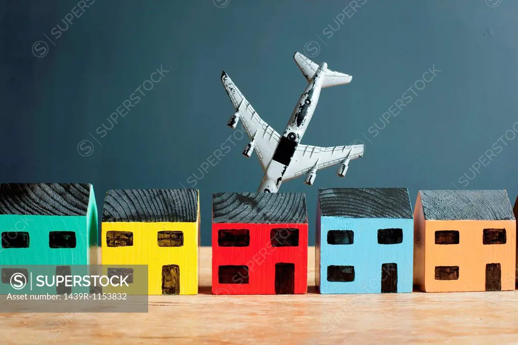 Plane crashing into model house