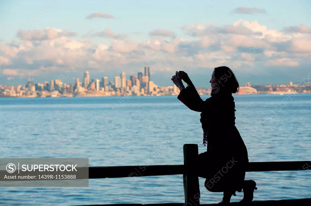 Woman taking picture of Seattle skyline