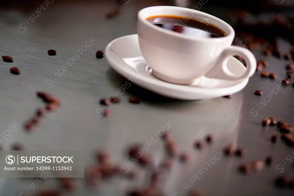 Cup of cappuccino with coffee beans
