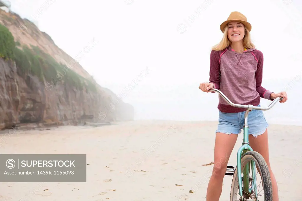 Woman on bicycle on beach