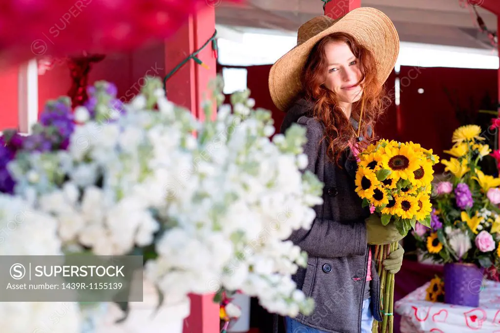 Florist holding bouquet in shop
