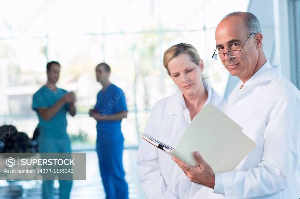 Two doctors discussing medical records