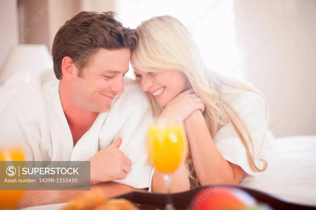 Young couple having breakfast in hotel room