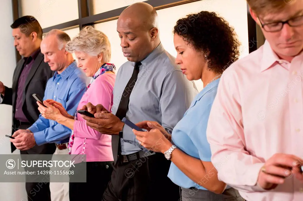 Business colleagues using cell phones