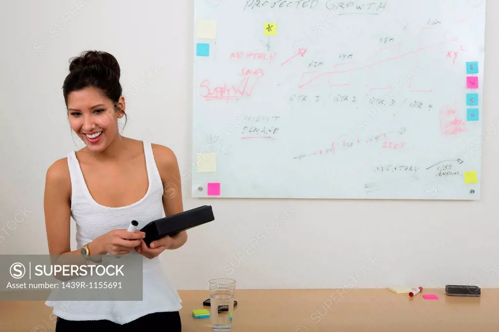 Young woman with whiteboard in background