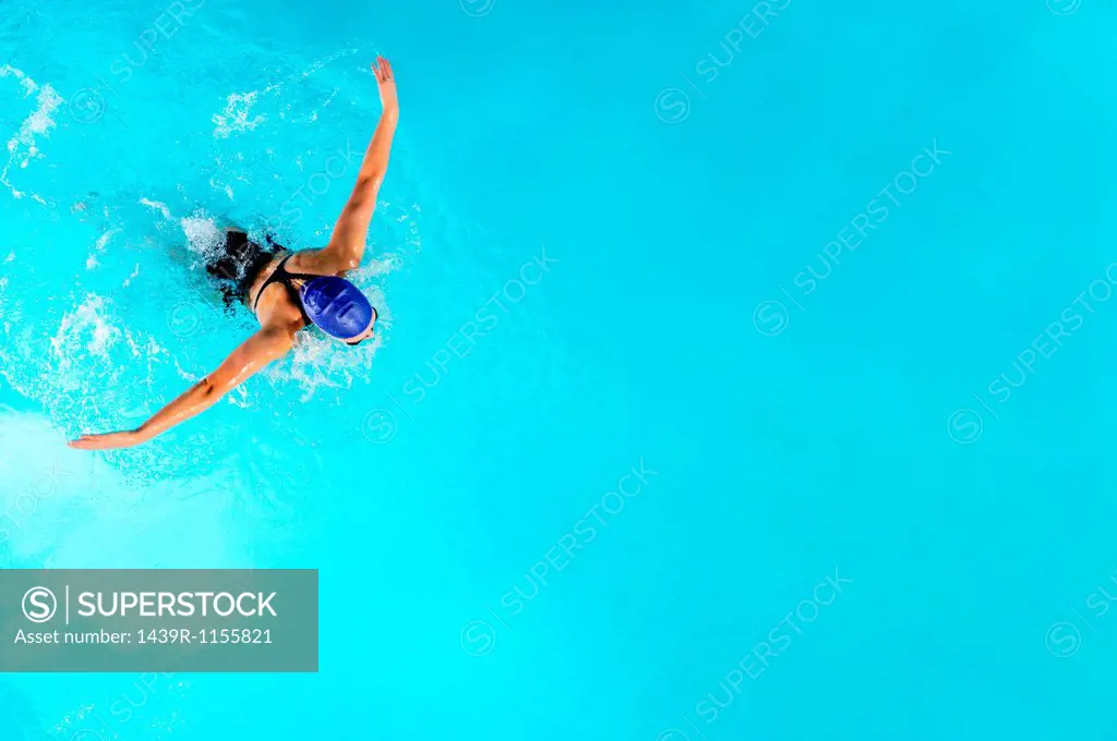 Teenage girl swimming in swimming pool