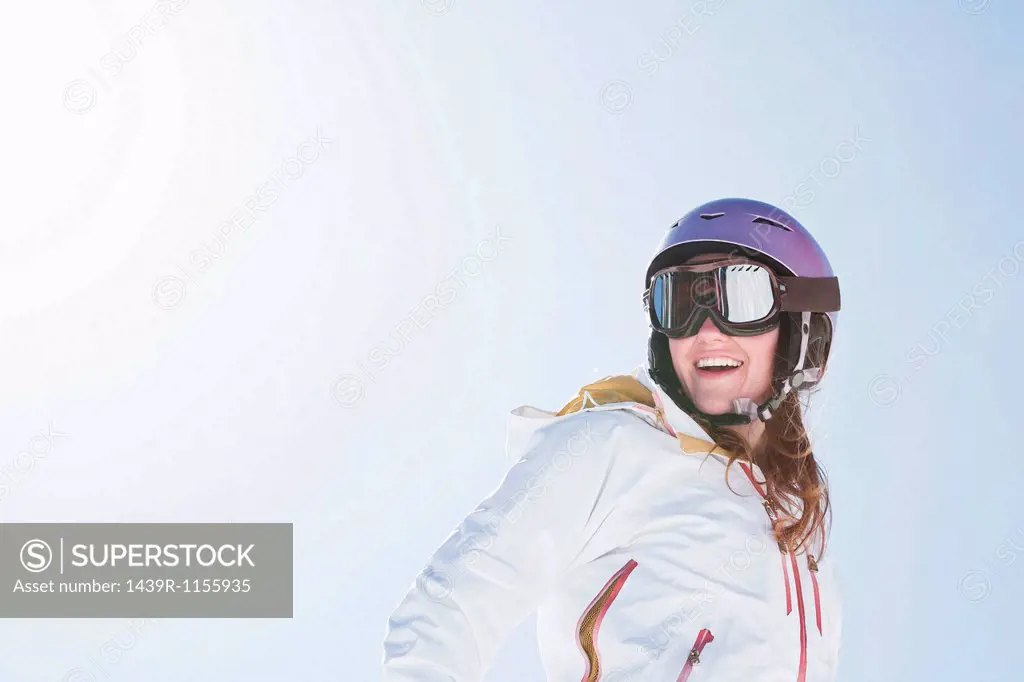 Young woman wearing ski goggles and helmet