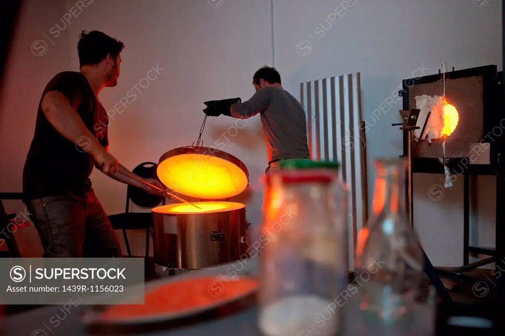 Two men working in glass factory