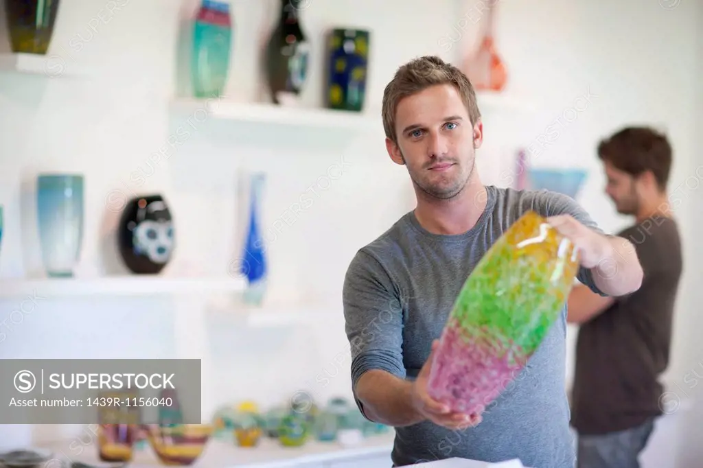 Man holding glass vase