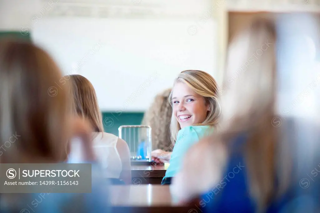Girl turning around to look at her classmates