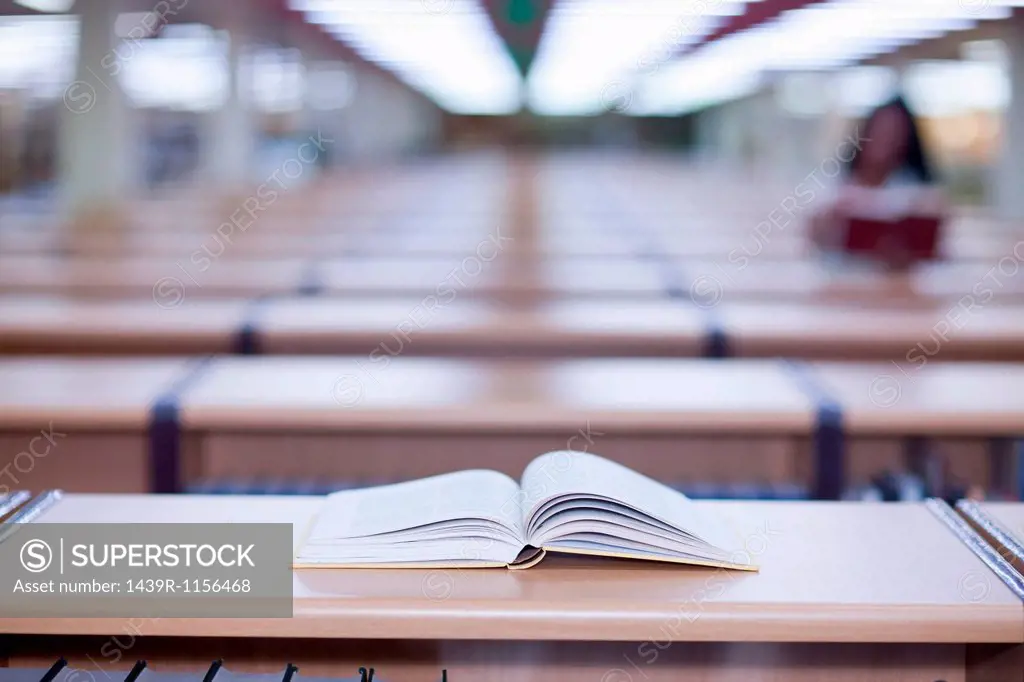 Open book on desk in library