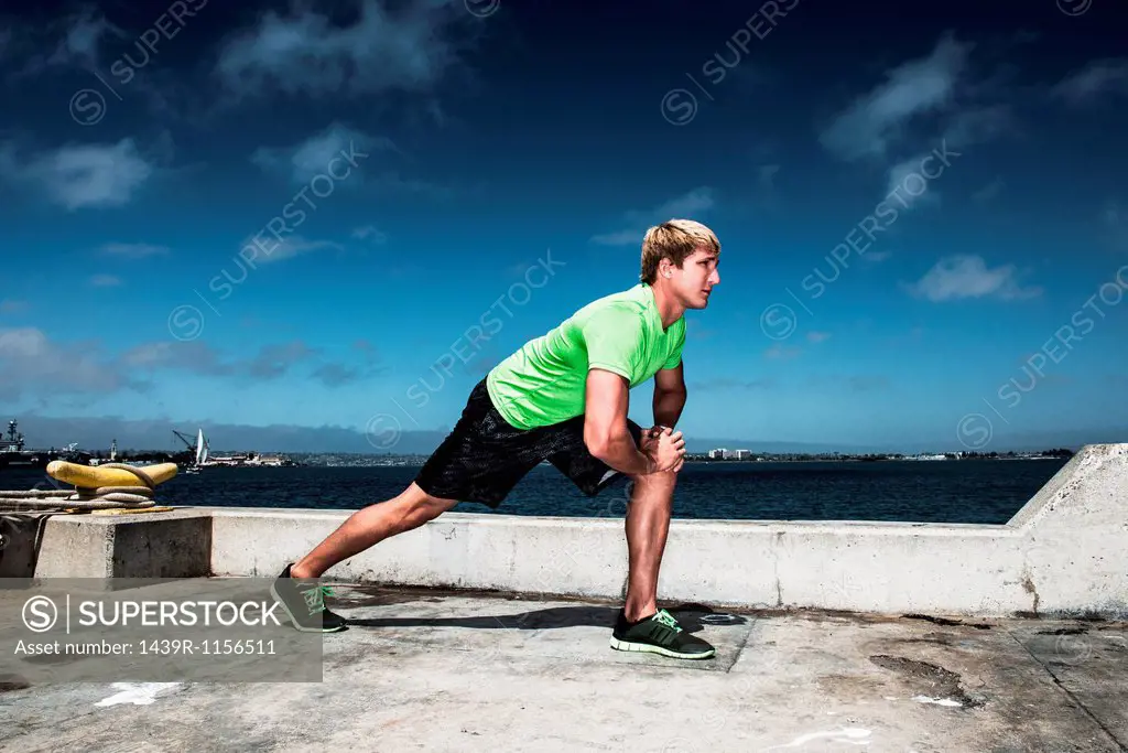 Young man warming up before exercise