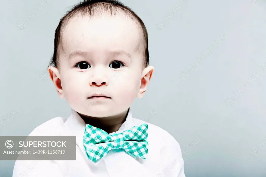 Portrait of baby boy wearing shirt and bow tie