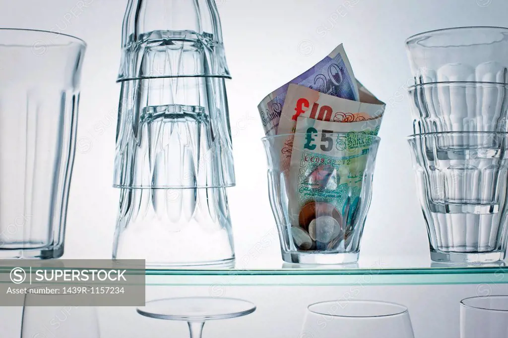 British currency in glass on shelf
