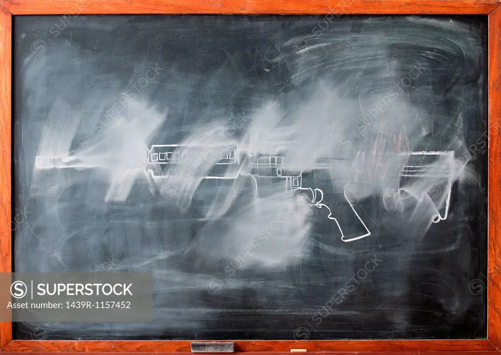 Partially erased chalk drawing of gun on blackboard
