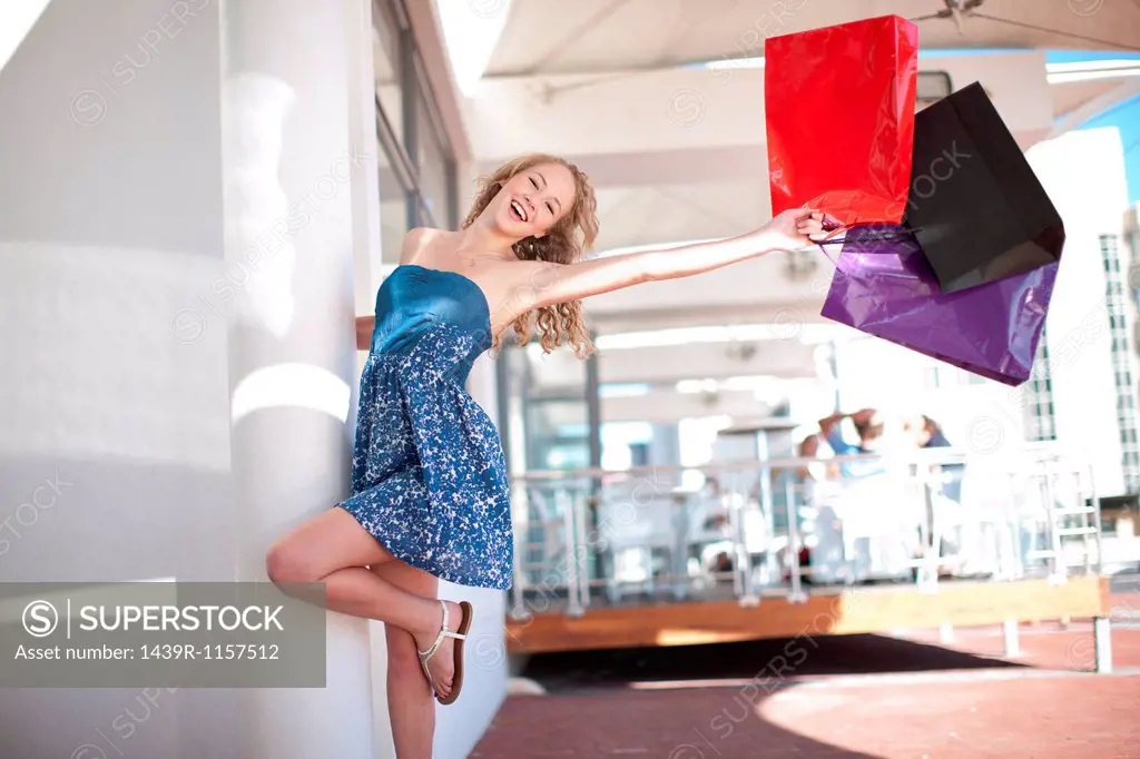 One happy young women swinging shopping bags