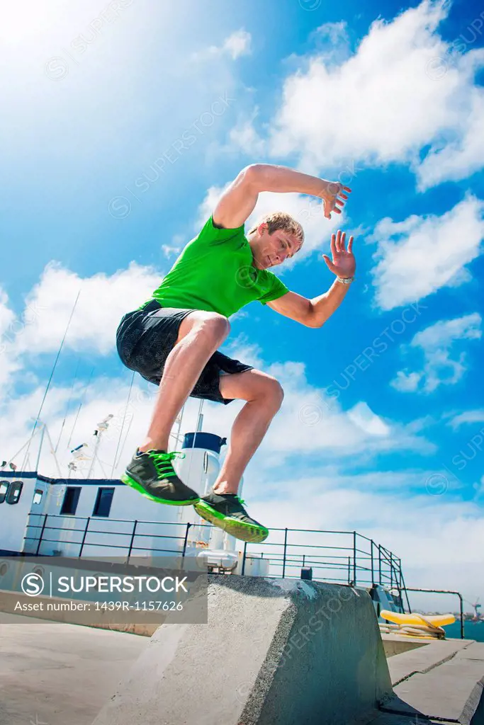 Young man jumping while fitness training
