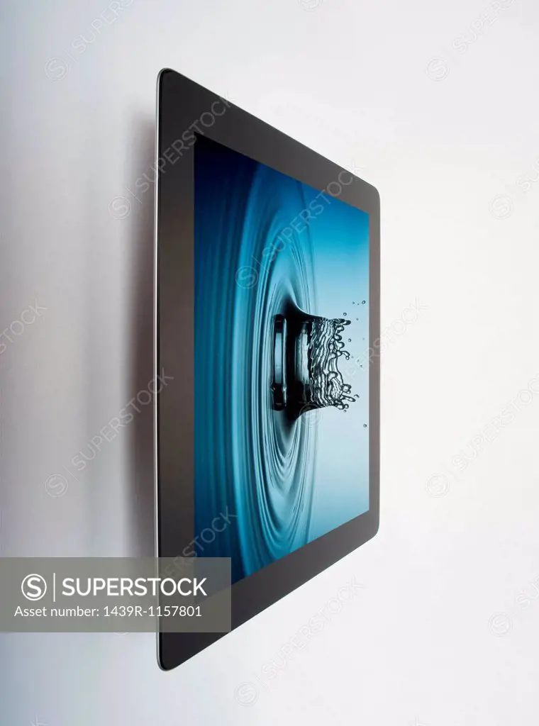 Digital tablet with crown shaped water drop splash on screen