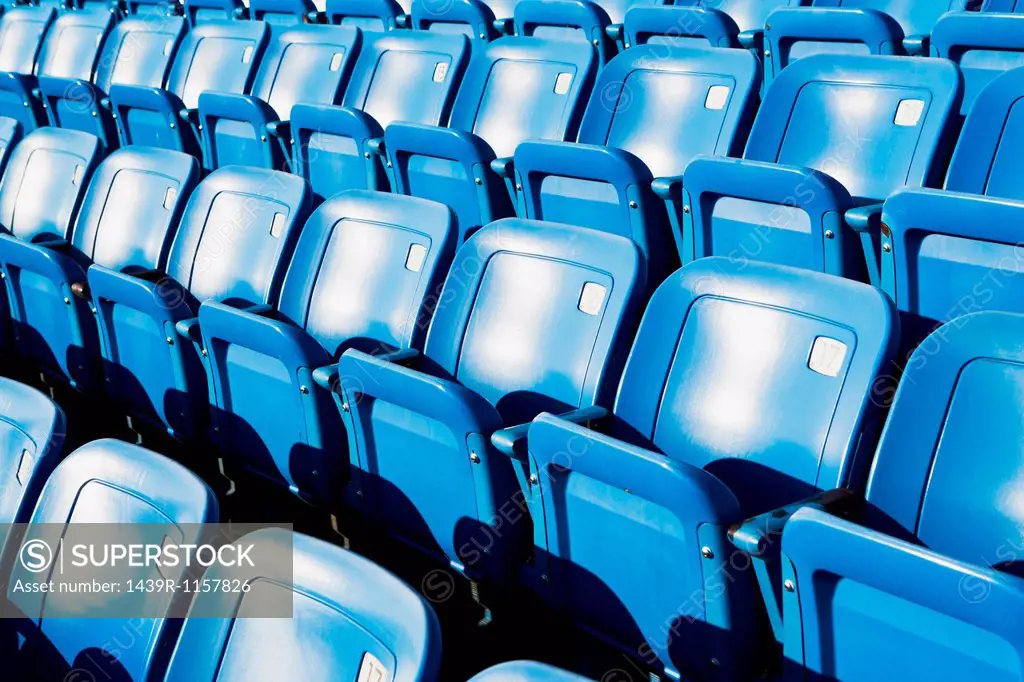 Empty blue seating in sports stadium