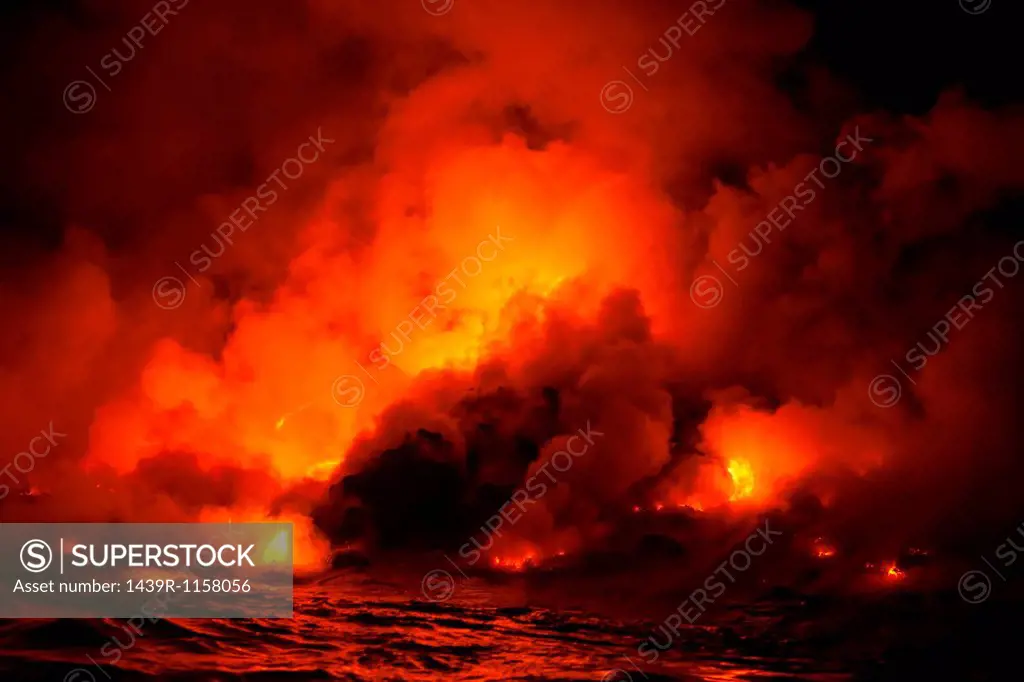 Smoke clouds from lava flow impacting sea at night, Kilauea volcano, Hawaii