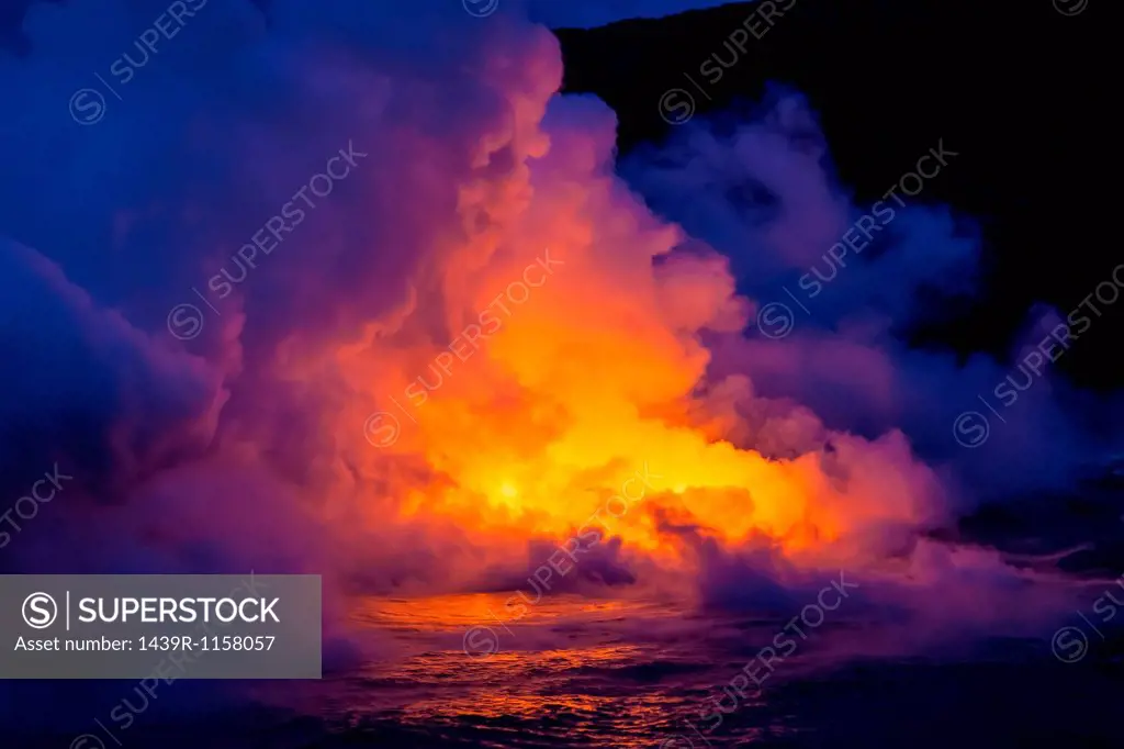 Smoke clouds from lava flow impacting sea at dusk, Kilauea volcano, Hawaii