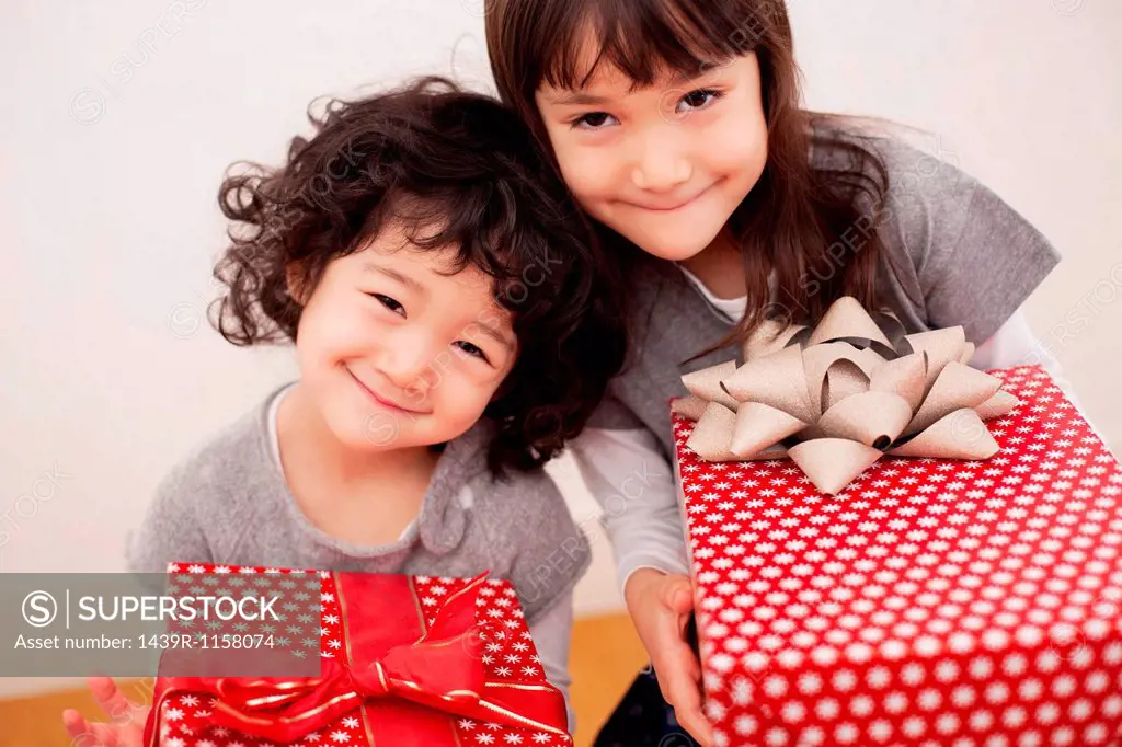 Sisters holding Christmas presents