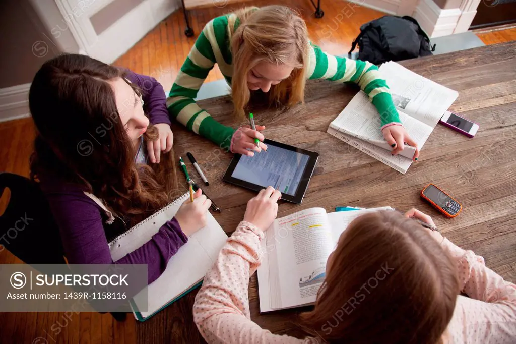 Girls sitting at table studying