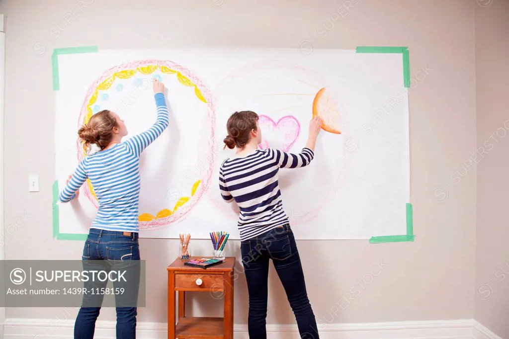 Girls drawing on wall