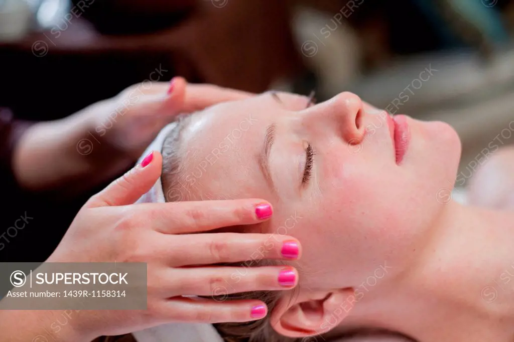 Young woman having facial treatment