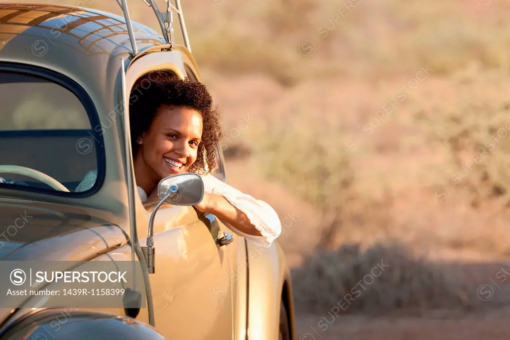 Young woman sitting in car, portrait