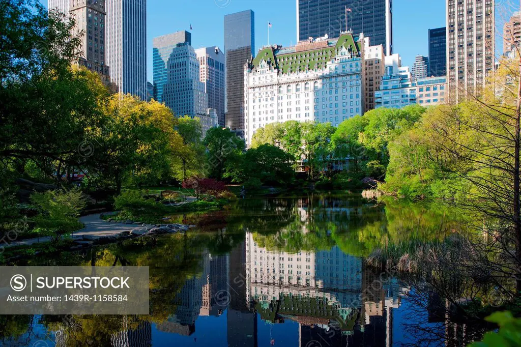 Buildings on lake in Central Park, New York City, USA