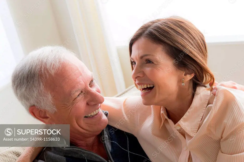 Mature woman and senior man hugging, laughing