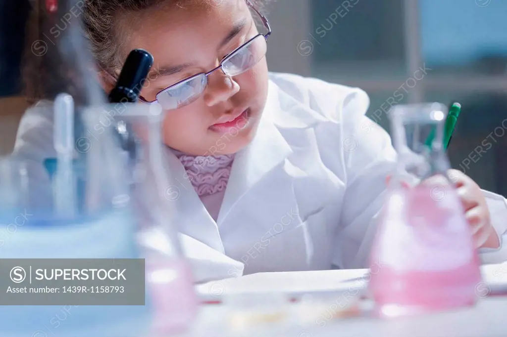 Girl making notes in laboratory