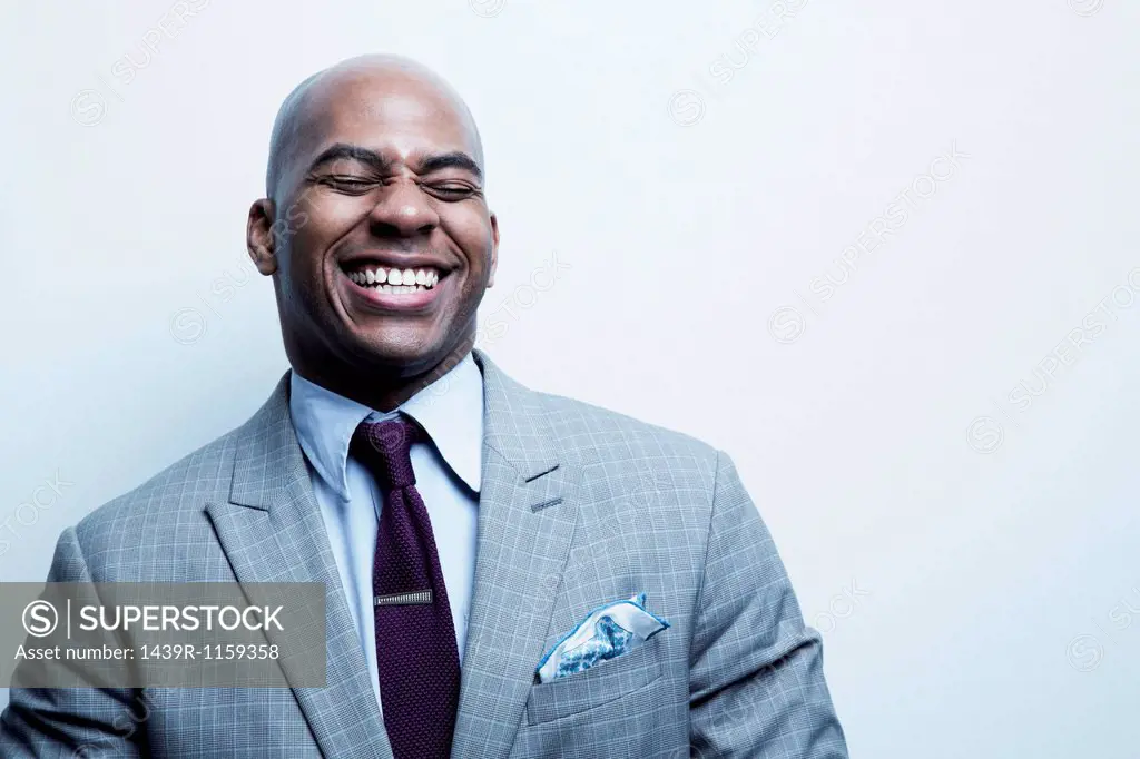 Studio portrait of businessman laughing