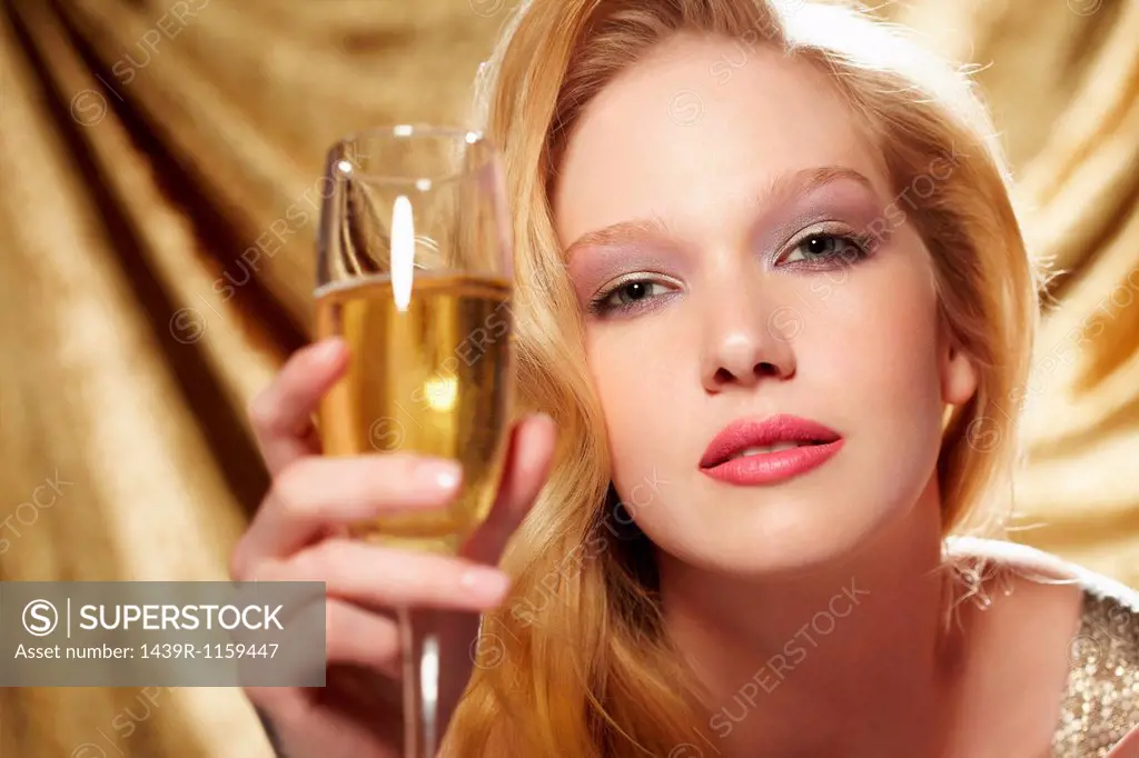 Portrait of young woman holding champagne flute