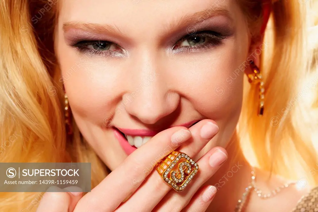 Close up portrait of young woman wearing diamond signet ring