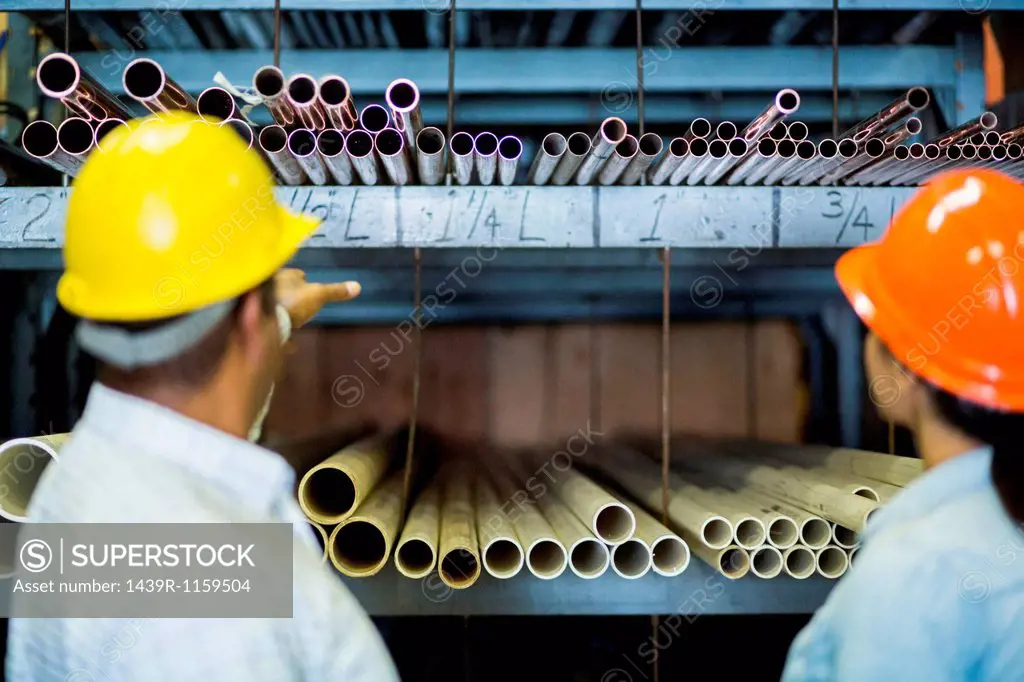 Close up of two warehouse workers in front of shelves