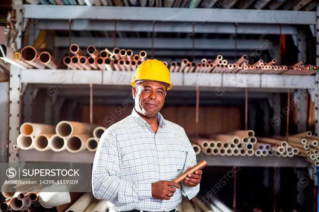 Man in warehouse with copper pipe