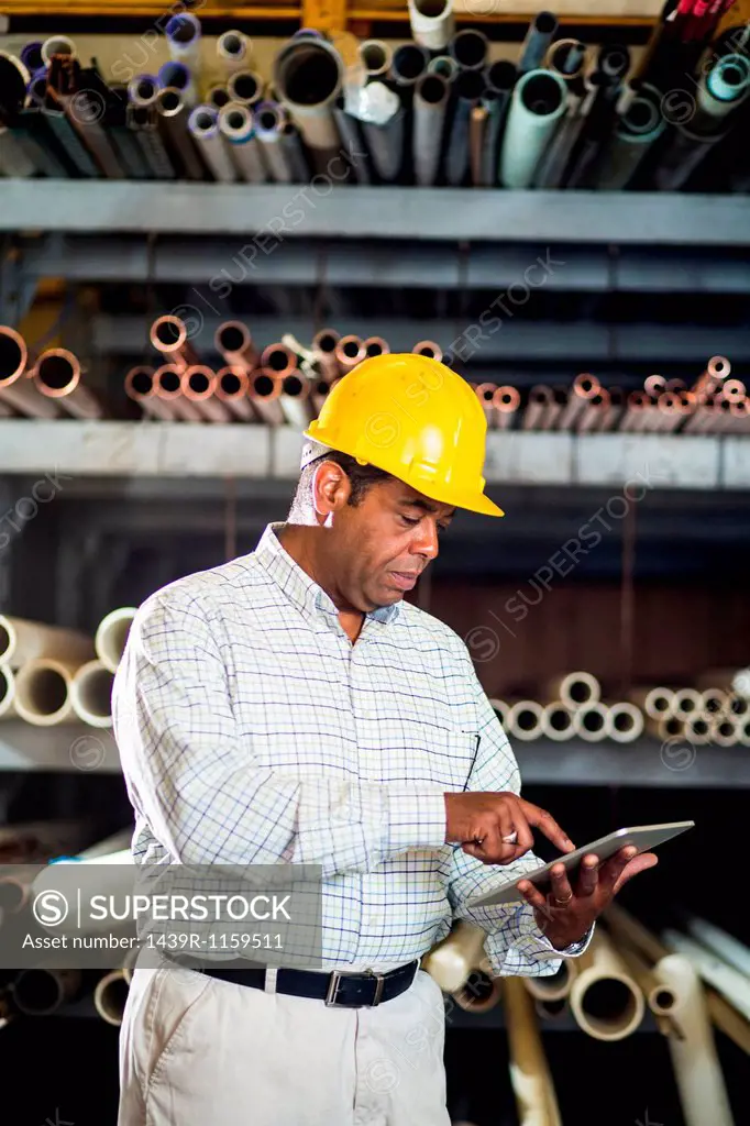 Man in warehouse with digital tablet