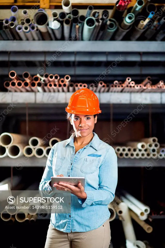Woman in warehouse with digital tablet