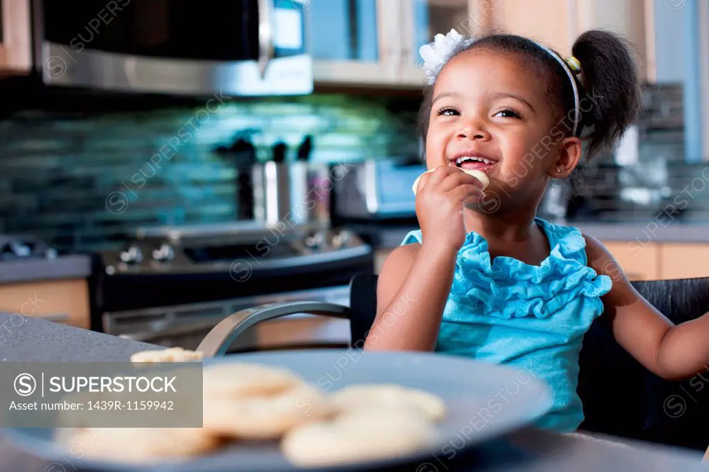 Young girl eating biscuits