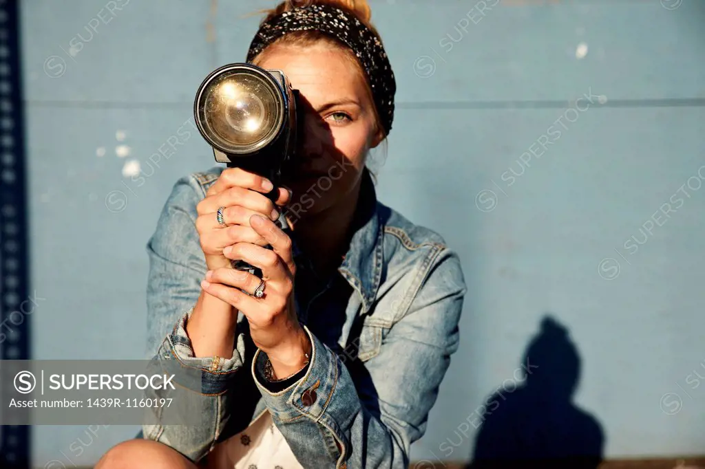 Woman using old video camera